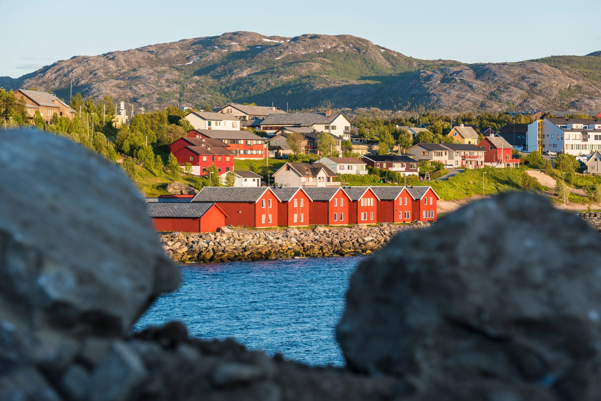 Red houses facades reflecting on the bay of Alta, Norway shutterstock_266192060